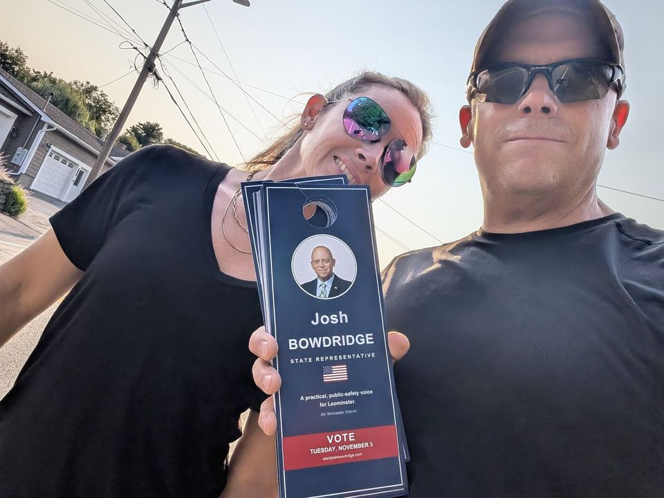 Josh and a volunteer with campaign palm cards