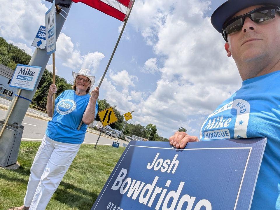 Sign-waving with supporters on a summer afternoon